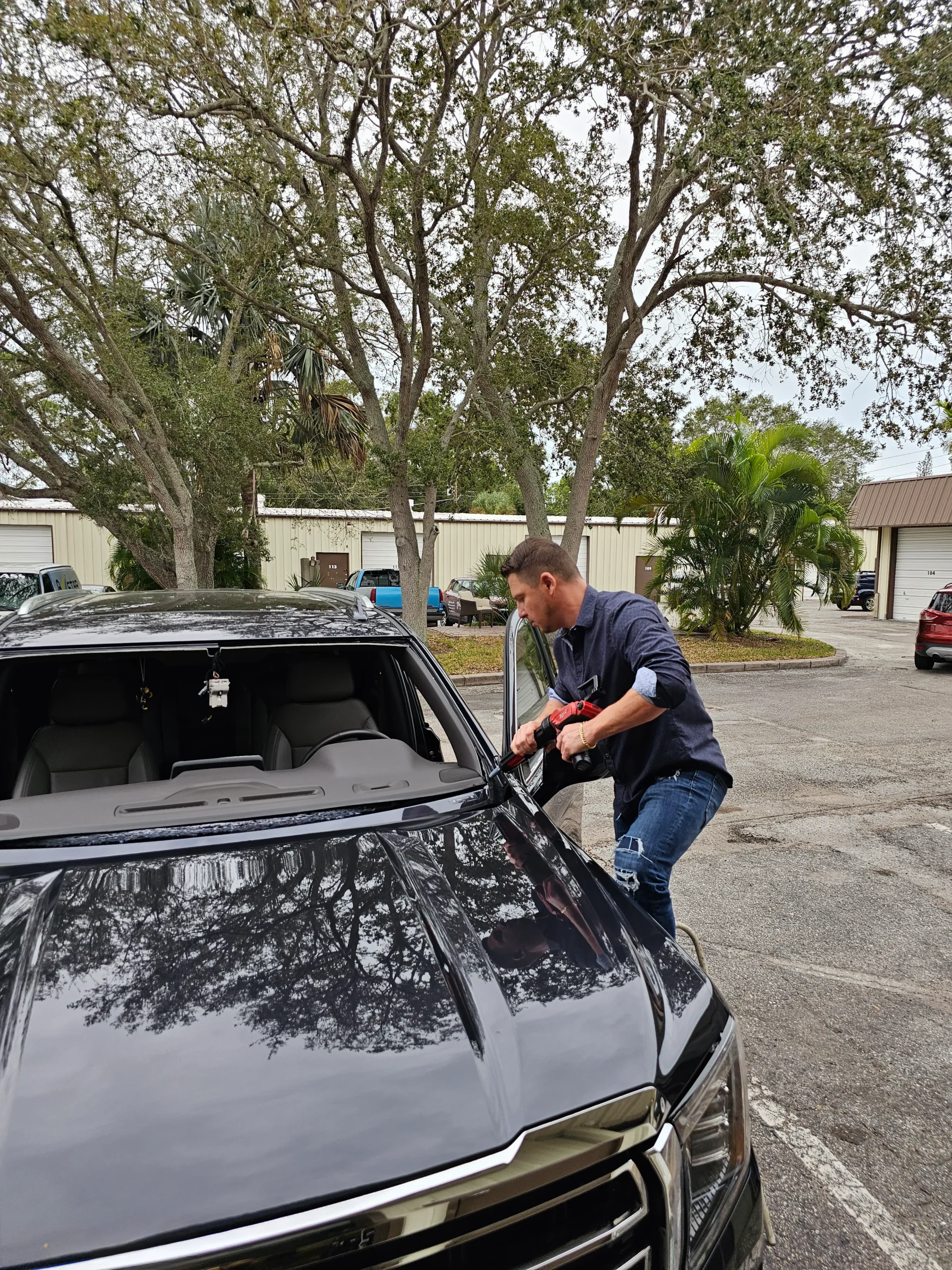 Alex Semencha installing a windshield at A Star Auto Glass shop in Sarasota FL